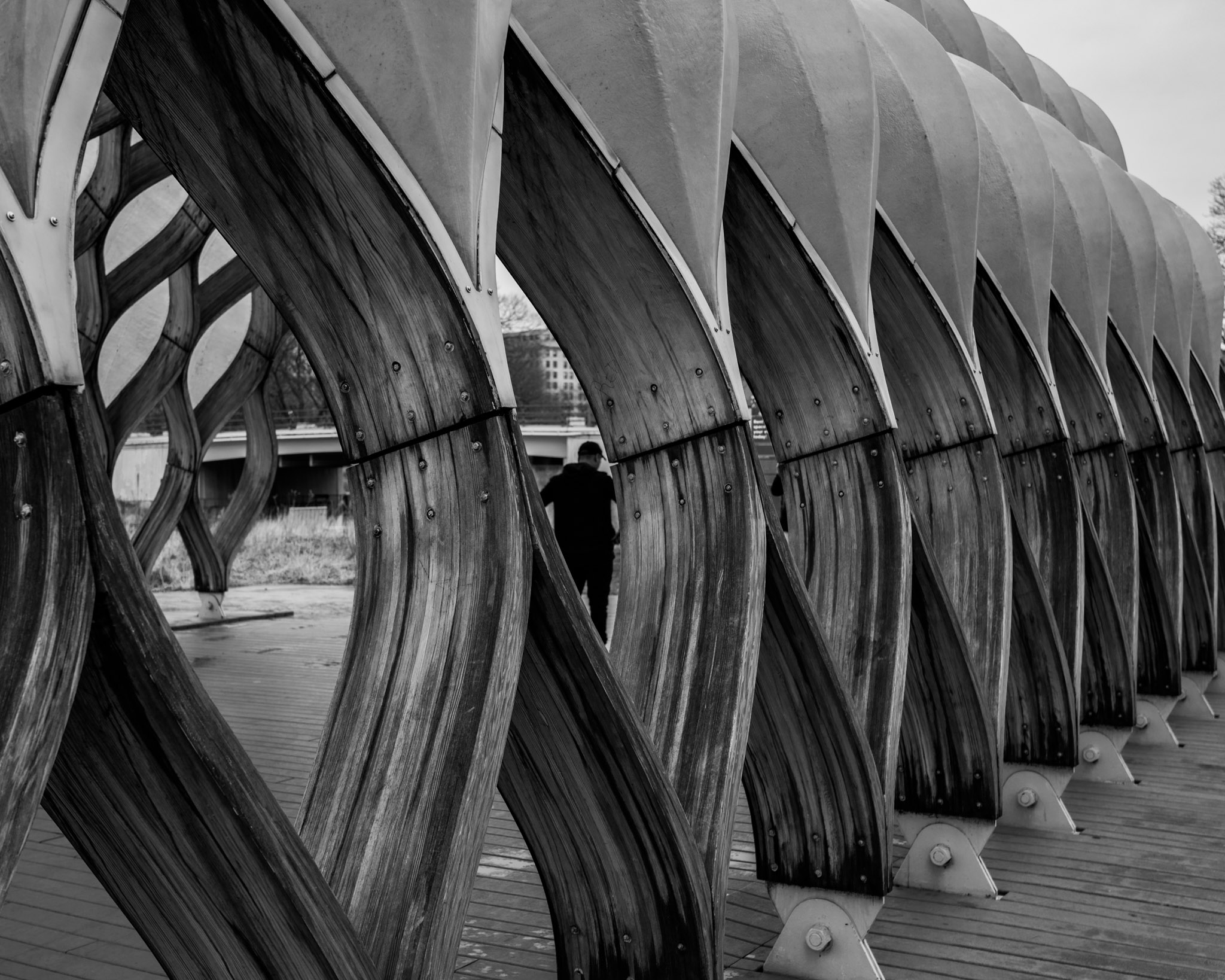 3 subjects walking on north avenue beach pier while chicago skyline towers in the background